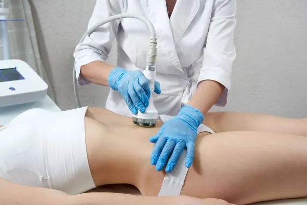 Lost the Weight but Not the Loose Skin? 2 woman having HIFU treatment on her stomach to combat loose skin Kings Lynn following weight loss